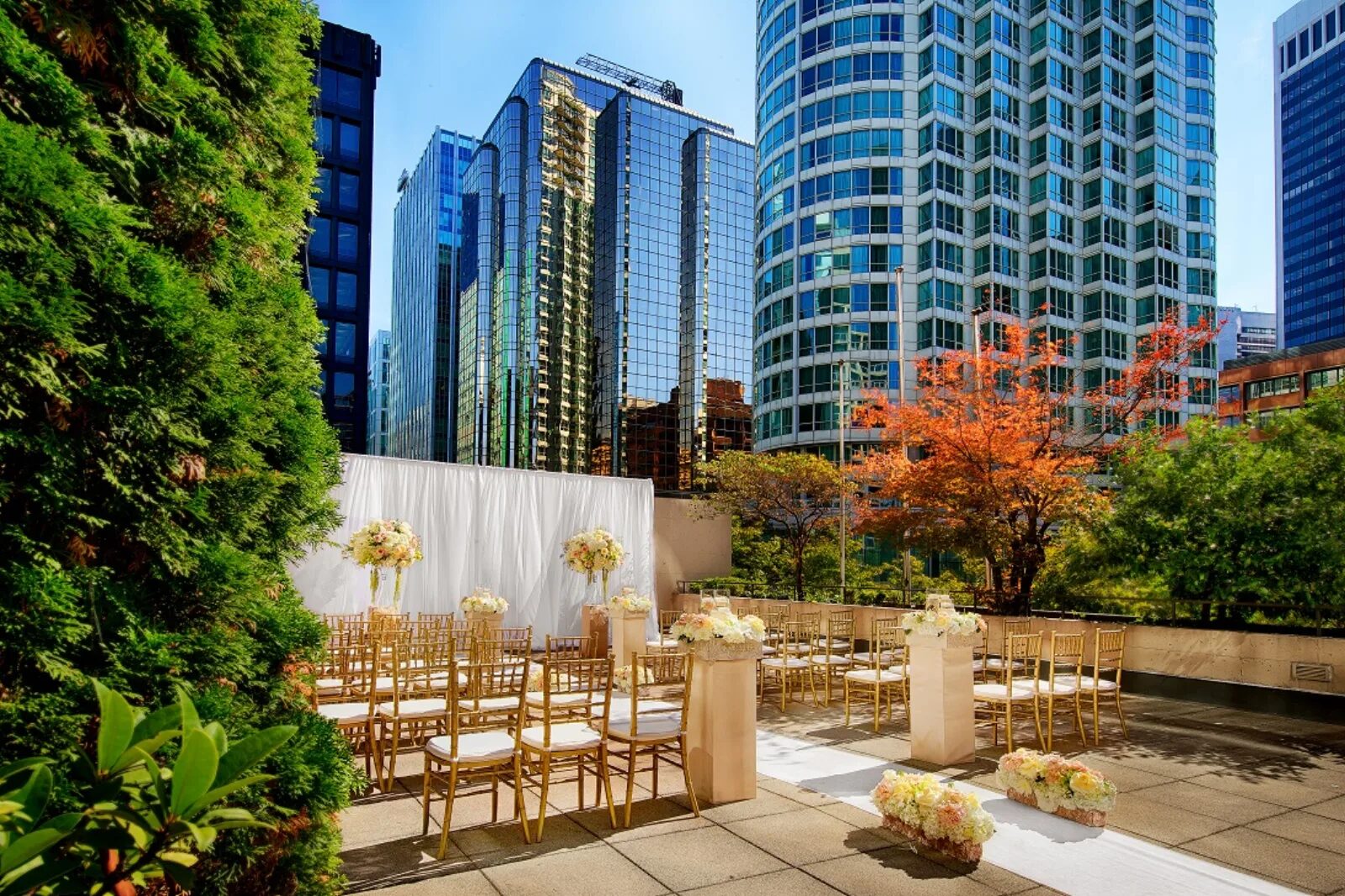 Outdoor terrace wedding ceremony with the Vancouver skyline at Pinnacle Hotel Harbourfront